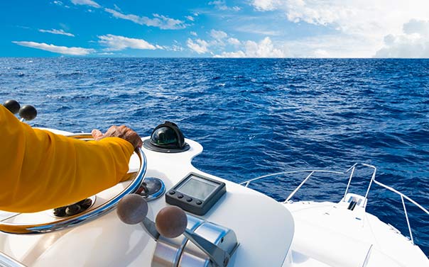 A person at sea steering a boat