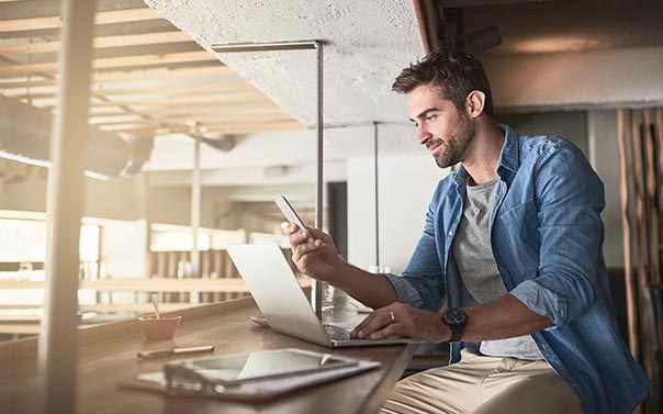 A young entrepreneur checkingemails on his phone